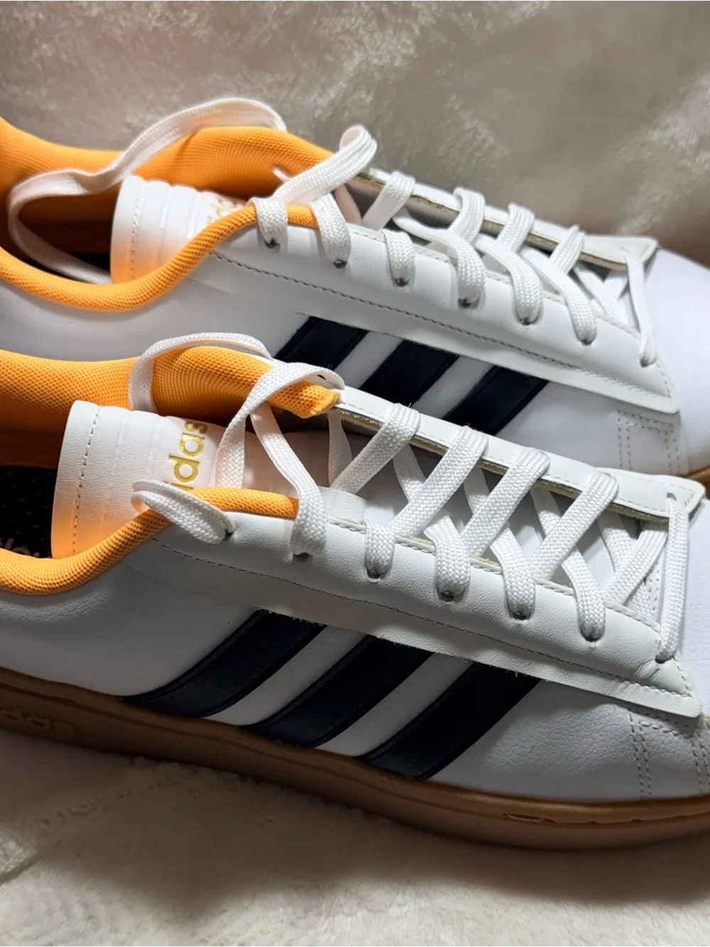 Adidas White Sneakers with Black Stripes and Yellow Lining